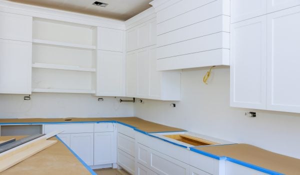 Installing new induction hob in modern kitchen kitchen Installation of kitchen cabinet.